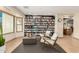 Inviting living room featuring neutral decor, tile flooring and a full wall of built-in bookshelves at 1938 E Myrna Ln, Tempe, AZ 85284