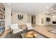 Bright living room featuring neutral decor, tile flooring and a full wall of built-in bookshelves at 1938 E Myrna Ln, Tempe, AZ 85284