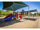 Bright community playground featuring slides, climbing structures, and covered play areas at 1938 E Myrna Ln, Tempe, AZ 85284