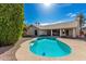 Backyard pool with a sun-drenched deck, surrounded by lush greenery and palm trees at 1938 E Myrna Ln, Tempe, AZ 85284