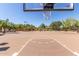 Full-sized basketball court surrounded by lush trees and landscaping for a fun outdoor experience at 22206 N 36Th Way, Phoenix, AZ 85050