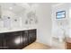 Bright bathroom with double vanity, dark wood cabinets, and a separate toilet room at 22206 N 36Th Way, Phoenix, AZ 85050