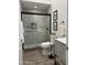 Modern bathroom featuring a glass shower, tile surround, pebble floor and a floating vanity at 22206 N 36Th Way, Phoenix, AZ 85050