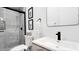 Modern bathroom featuring a tiled shower, sleek vanity, and contemporary black fixtures at 22206 N 36Th Way, Phoenix, AZ 85050