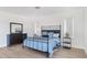 Bright bedroom featuring a wrought iron bed frame, wood floors, and white walls at 22206 N 36Th Way, Phoenix, AZ 85050