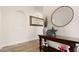 Stylish hallway with decorative table, artwork, round mirror, and accent lighting at 22206 N 36Th Way, Phoenix, AZ 85050