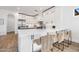 Modern kitchen with quartz countertops, sleek black hardware, and a breakfast bar area at 22206 N 36Th Way, Phoenix, AZ 85050