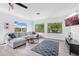 Bright and airy living room featuring a comfortable sectional, large windows, and stylish decor at 22206 N 36Th Way, Phoenix, AZ 85050