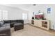 Cozy living room featuring a sectional sofa, entertainment center, and neutral carpet at 22206 N 36Th Way, Phoenix, AZ 85050