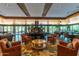 Lobby features a decorative rug, seating, and fireplace under a decorative ceiling with floor-to-ceiling windows at 22206 N 36Th Way, Phoenix, AZ 85050