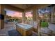 A patio area with a seating area, fire pit, TV, and view of the backyard and pool at 22206 N 36Th Way, Phoenix, AZ 85050