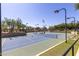 Well-maintained tennis court with lighting for evening play and landscaping, surrounded by lush trees at 22206 N 36Th Way, Phoenix, AZ 85050