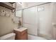 Compact bathroom featuring a vanity, toilet, and a shower-tub combination with sliding glass doors at 2237 E Windsor Ave, Phoenix, AZ 85006