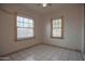 Bright bedroom featuring tiled floors and natural light from two windows with blinds at 2237 E Windsor Ave, Phoenix, AZ 85006