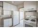 Functional kitchen featuring classic white cabinetry and appliances with durable tiled flooring at 2237 E Windsor Ave, Phoenix, AZ 85006