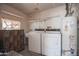 Laundry room featuring washer, dryer, vintage dresser and utility sink at 2237 E Windsor Ave, Phoenix, AZ 85006