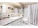 Neutral bathroom featuring a sink with white cabinetry and a shower with a curtain at 25236 S Lakeway Dr, Sun Lakes, AZ 85248