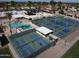 Aerial view showcasing the community pool, tennis courts, and surrounding neighborhood at 25236 S Lakeway Dr, Sun Lakes, AZ 85248