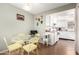 Cozy kitchen dining nook with a glass table and modern appliances with white cabinetry and neutral colors at 25236 S Lakeway Dr, Sun Lakes, AZ 85248