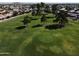 An aerial view shows the meticulously maintained golf course with mature trees at 25236 S Lakeway Dr, Sun Lakes, AZ 85248