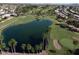 An aerial view of the community golf course and a serene pond amidst lush greenery at 25236 S Lakeway Dr, Sun Lakes, AZ 85248