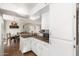 Cozy kitchen featuring white cabinetry, countertop space and view into the dining area at 25236 S Lakeway Dr, Sun Lakes, AZ 85248