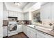 Bright kitchen featuring white cabinetry, tile backsplash, and window over the sink at 25236 S Lakeway Dr, Sun Lakes, AZ 85248