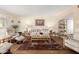 Bright living room featuring a cozy seating area, wood-look floors, and stylish decor with natural light at 25236 S Lakeway Dr, Sun Lakes, AZ 85248