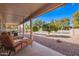 Covered patio area perfect for relaxation and outdoor enjoyment with views of the lush backyard and serene pond at 25236 S Lakeway Dr, Sun Lakes, AZ 85248