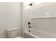 Clean, white bathroom with a tiled shower-over-tub, matte black fixtures, and a matching toilet at 25372 N 158Th Ct, Surprise, AZ 85387