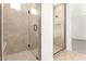 Walk-in shower features elegant tile work and a sleek glass door creating a spa-like experience in this bathroom at 25372 N 158Th Ct, Surprise, AZ 85387