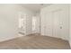 Bright bedroom featuring neutral carpet, white walls, and double door closet at 25372 N 158Th Ct, Surprise, AZ 85387