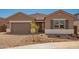 Inviting single-story home featuring a paver driveway, a tile roof, and desert landscaping at 25372 N 158Th Ct, Surprise, AZ 85387