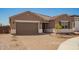 Inviting home with a paver driveway leading to a two-car garage, complemented by desert landscaping at 25372 N 158Th Ct, Surprise, AZ 85387