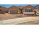 Charming single-story home with a low-maintenance front yard and brick-paved driveway leading to a two-car garage at 25372 N 158Th Ct, Surprise, AZ 85387