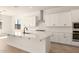 Bright kitchen with white cabinets, stainless steel appliances, and a spacious center island perfect for entertaining at 25372 N 158Th Ct, Surprise, AZ 85387