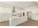 Bright kitchen with white cabinets, stainless steel appliances, and a spacious center island perfect for meal preparation at 25372 N 158Th Ct, Surprise, AZ 85387