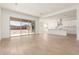 Open-concept living space featuring tile flooring, neutral walls, recessed lighting, and a large glass sliding door to the yard at 25372 N 158Th Ct, Surprise, AZ 85387