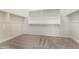A large, empty walk-in closet with carpet flooring, with closet rods and shelving at 25372 N 158Th Ct, Surprise, AZ 85387