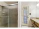 Bathroom featuring a glass enclosed shower and exterior access at 2558 E Inglewood St, Mesa, AZ 85213