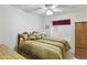 Bedroom featuring a ceiling fan and large bed with decorative pillows and matching curtains at 2558 E Inglewood St, Mesa, AZ 85213