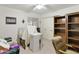 Simple bedroom with a built in bookcase, ceiling fan, and a large closet at 2558 E Inglewood St, Mesa, AZ 85213