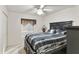 Cozy bedroom with a decorative ceiling fan and a large window with blinds at 2558 E Inglewood St, Mesa, AZ 85213