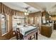 Inviting dining area boasts natural light, a ceiling fan, and views of the pool at 2558 E Inglewood St, Mesa, AZ 85213