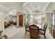 Formal dining area featuring a chandelier, large windows and view to the living area at 2558 E Inglewood St, Mesa, AZ 85213