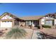 Charming single-story brick home featuring a well-manicured yard and inviting front porch at 2558 E Inglewood St, Mesa, AZ 85213