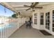 A covered outdoor patio with a ceiling fan and ample seating overlooks the refreshing pool and yard at 2558 E Inglewood St, Mesa, AZ 85213