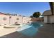 Private swimming pool with a connected jacuzzi surrounded by a walled backyard, creating an oasis at 2558 E Inglewood St, Mesa, AZ 85213