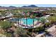 Aerial shot of community pool area with palm trees, lounge chairs, and shade structures at 2843 E Los Gatos Dr, Phoenix, AZ 85050