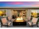 Backyard seating area with a modern fire pit and views of the home's stylish exterior at 2843 E Los Gatos Dr, Phoenix, AZ 85050